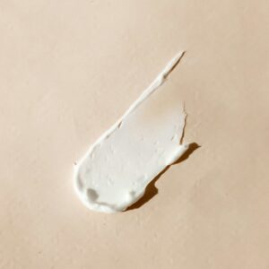 white cream smear on beige surface